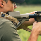 A man using a rifle sling from Flatline Fiber while shooting his rifle.