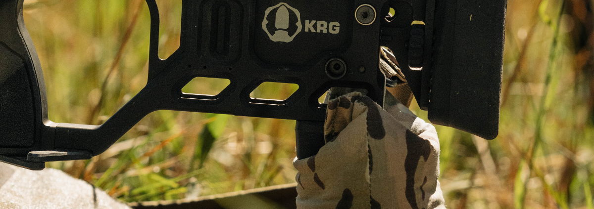 A brown camo shooting bag (Baseline Bag) by Flatline Fiber used to hold up a rifle stock.